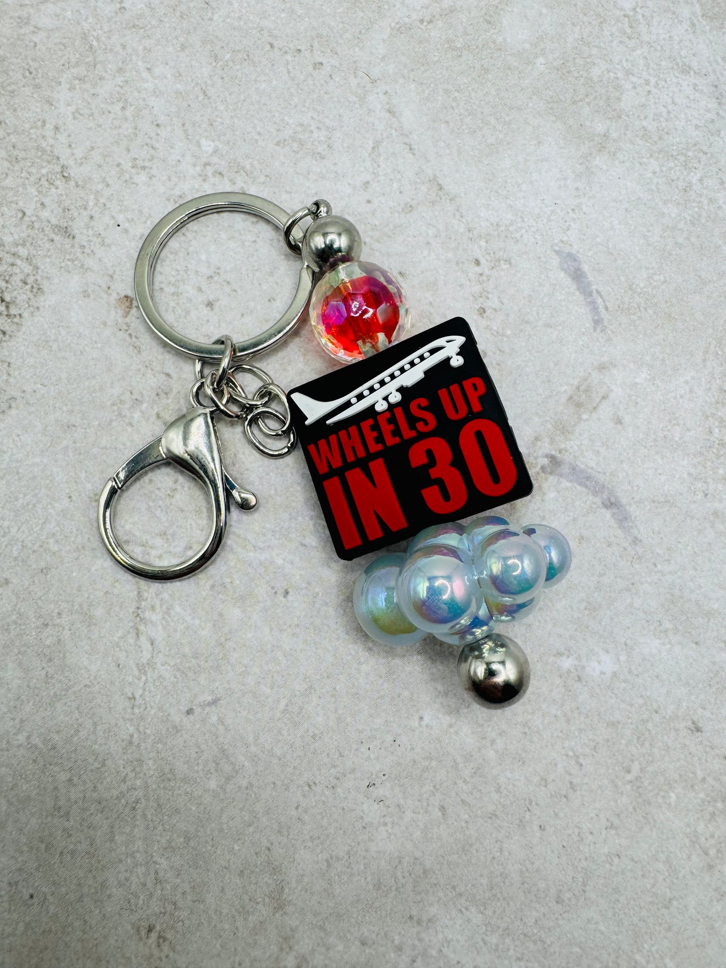 Wheels up in 30 keychain